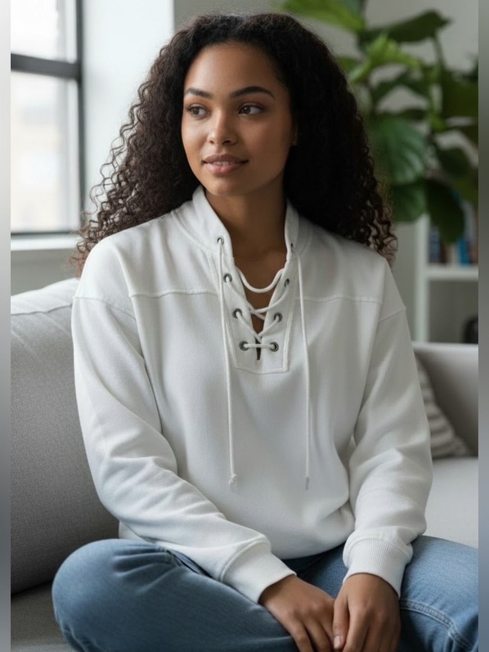 White oversized hooded sweatshirt with metal brad and rope ties.